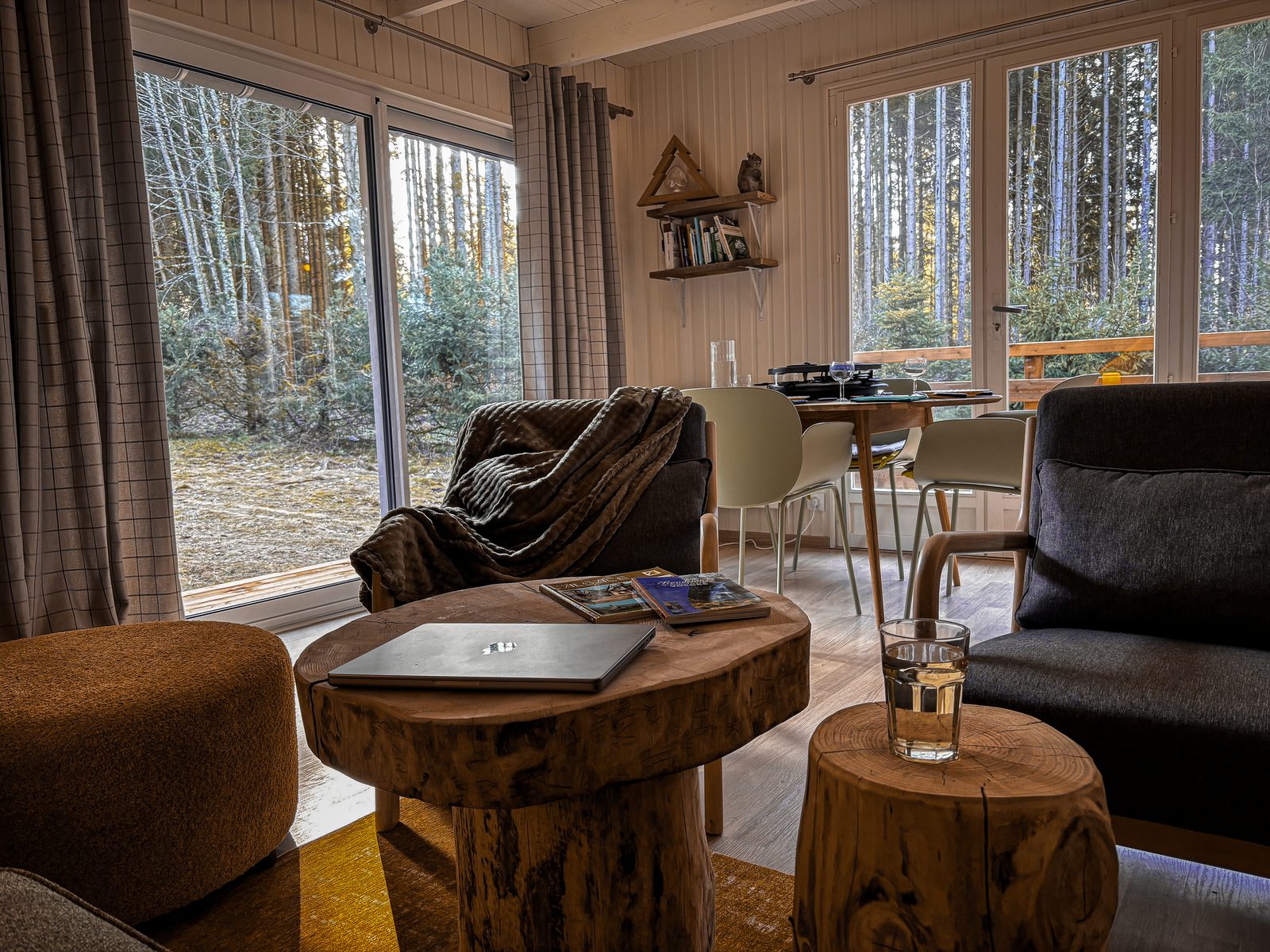 Heller Wohnbereich mit Panoramafenstern en Waldblick